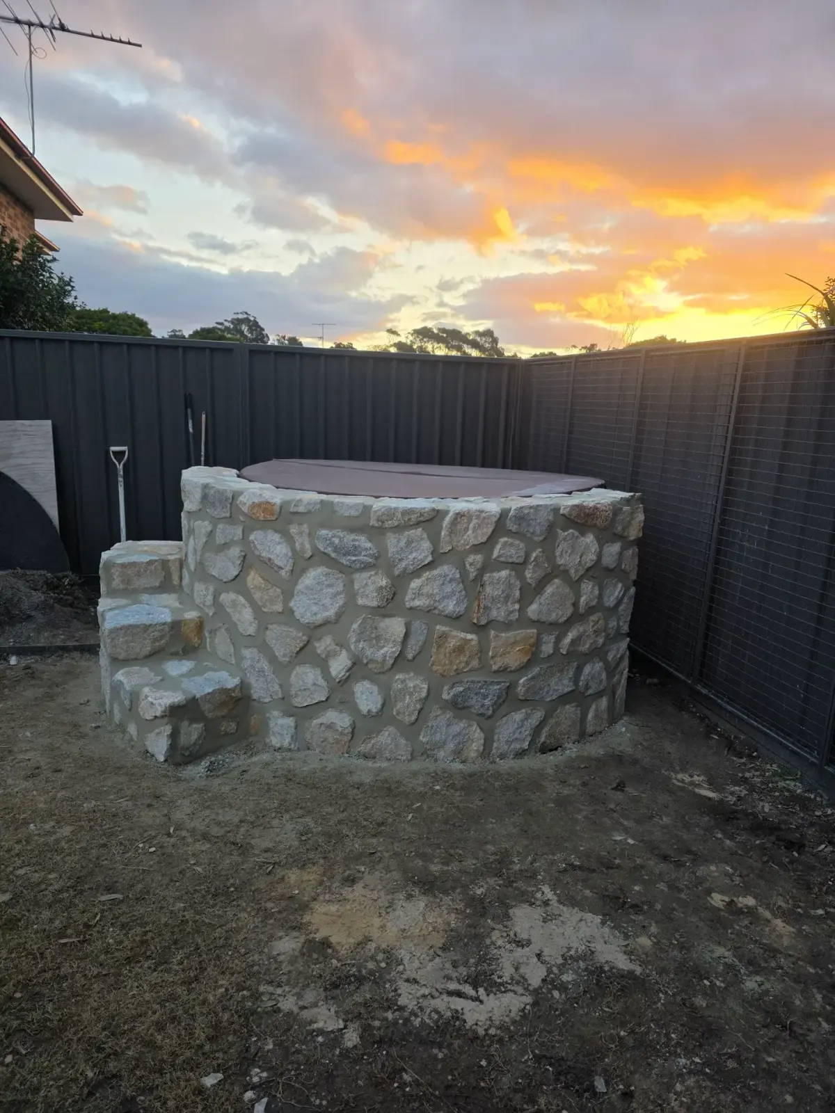 Stone cladding around the curved spa feature at the Malabar project